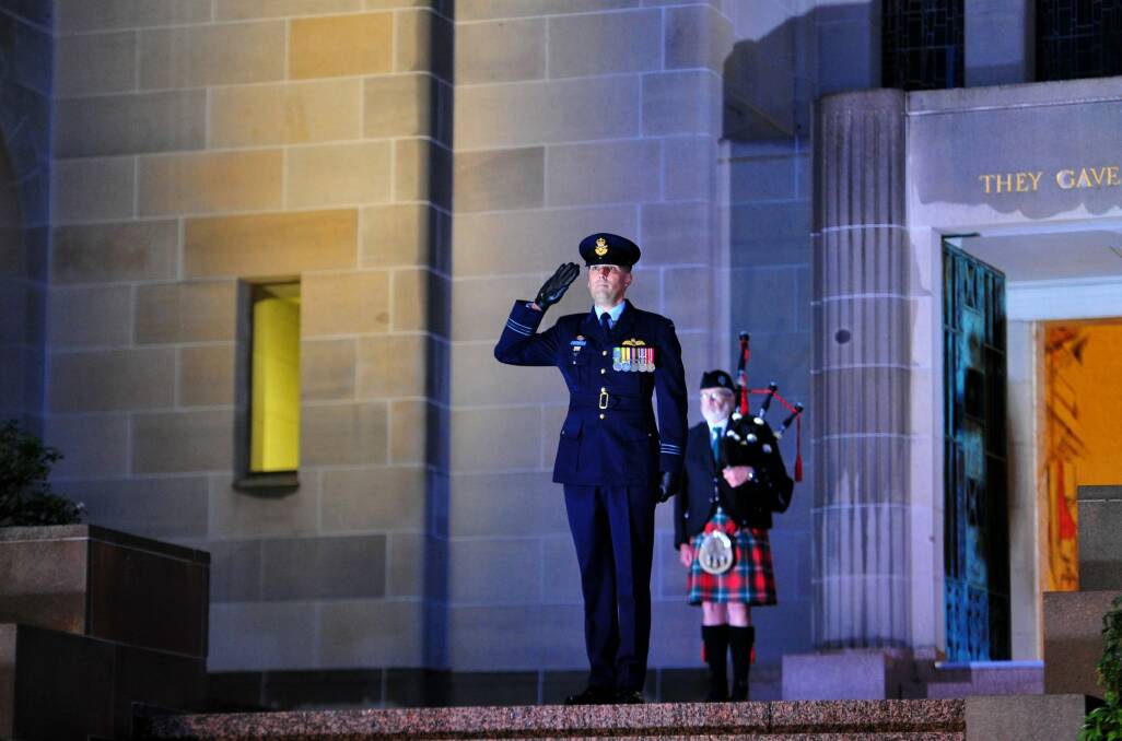 Squadron Leader Marcus Watson during the Last Post ceremony at the Australian War Memorial in Canberra for Flight Lieutenant John Napier Bell.  Photo: Melissa Adams