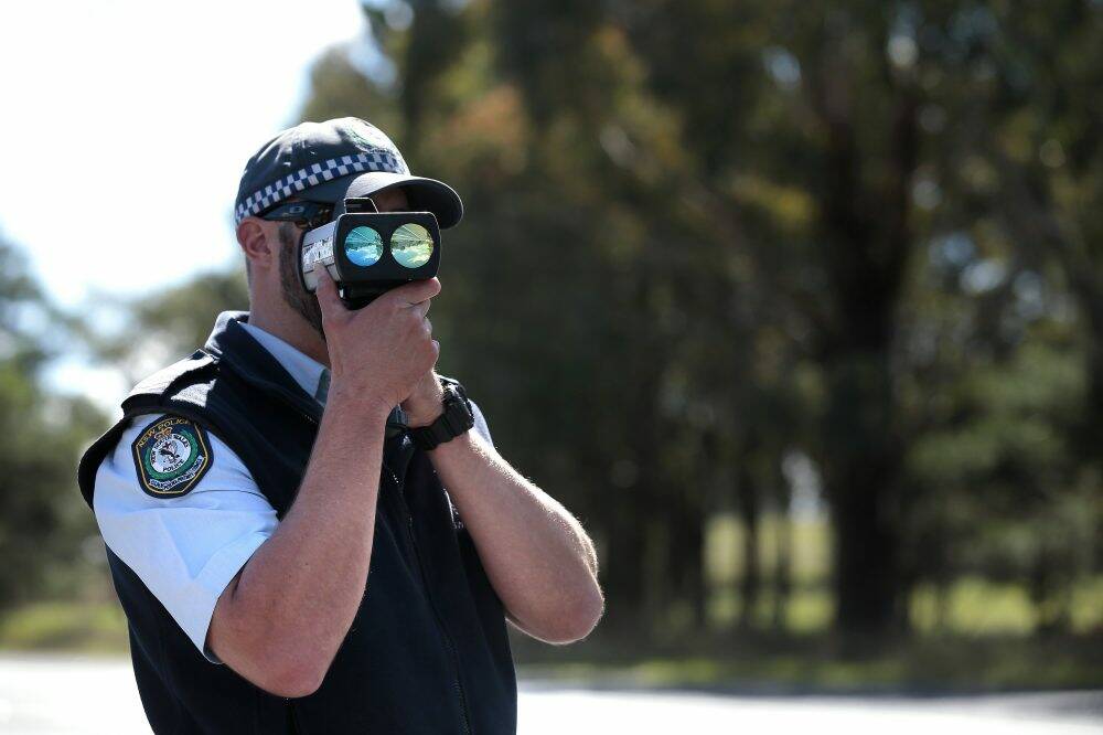 A NSW Police officer checks speed during the launch of Operation Crossroads last year.