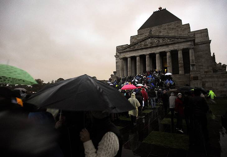 Crowds brave miserable conditions to pay their respects at the dawn service at Melbourne's Shrine of Remembrance. Photo: Penny Stephens