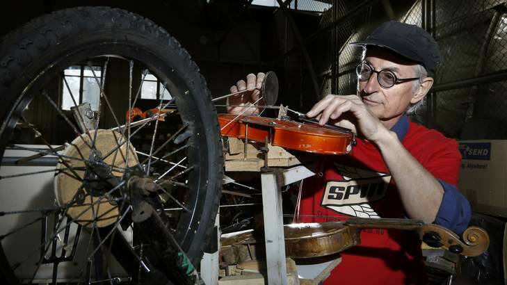 Composer Jon Rose and his bike, which features two fiddles. Photo: Jeffrey Chan