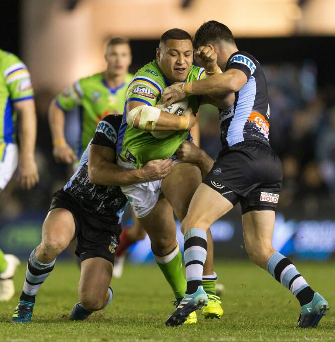 Josh Papalii of the Raiders is tackled by Chad Townsend. Photo: Craig Golding