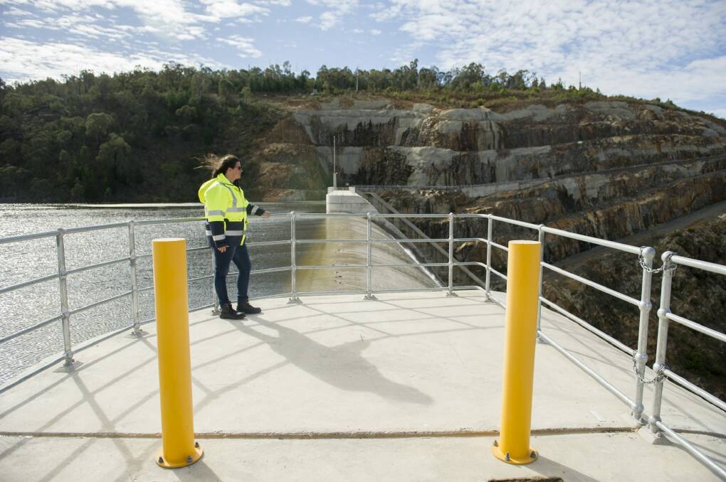 Icon Water community engagement officer Ellen Schwab watching the water spill over the Cotter Dam wall.
 Photo: Jay Cronan