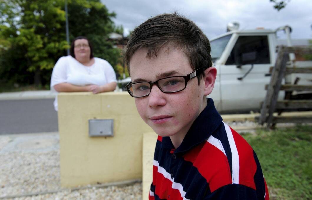 Danielle McMahon, of Ngunnawal, at  home with her 13-year-old
autistic son, Jay.  Photo: Graham Tidy