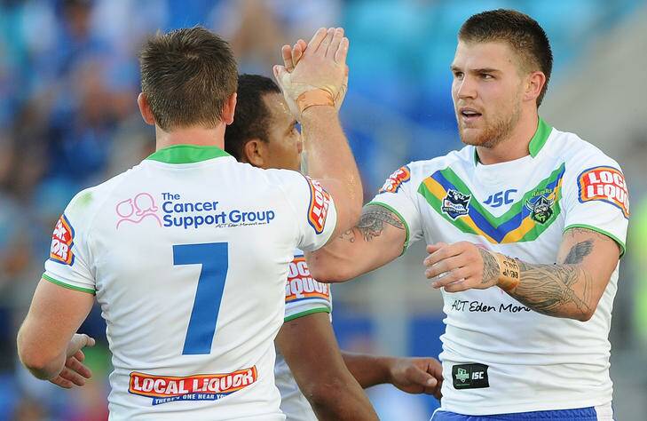 Josh Dugan of the Raiders celebrates with Travis Waddell (obscured) and Josh McCrone (7) during the round two NRL match between the Gold Coast Titans and the Canberra Raiders at Skilled Park on March 10, 2012 in Gold Coast, Australia.  (Photo by Matt Roberts/Getty Images) Photo: Matt Roberts
