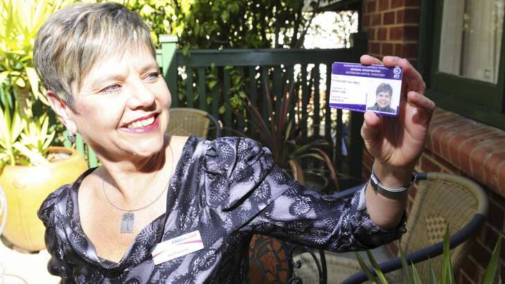 Anglicare worker Ann Ponsonby holding her working with vulnerable people card. Photo: Melissa Adams