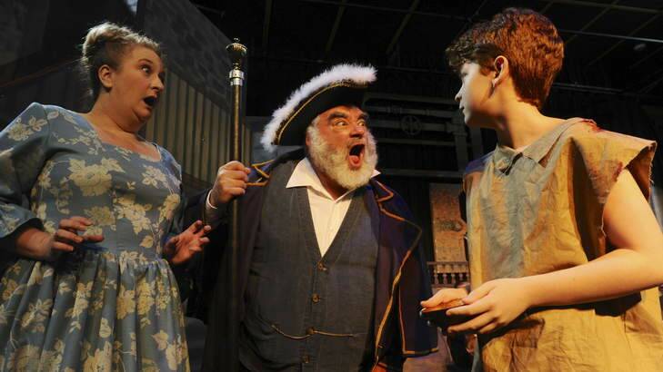 Media call for "Oliver the Musical" at the Belconnen Theatre. Cast members including, Mr Bumble (Michael Miller), Widow Corney (Debra Byrne) and Oliver Twist (Ben Burgess) right,  during a scene. Photo: Graham Tidy