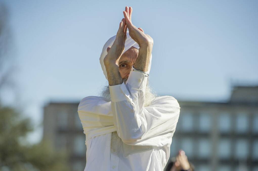Canberrans participate in an outdoor yoga class to mark the official International Day of Yoga. Photo: Jay Cronan