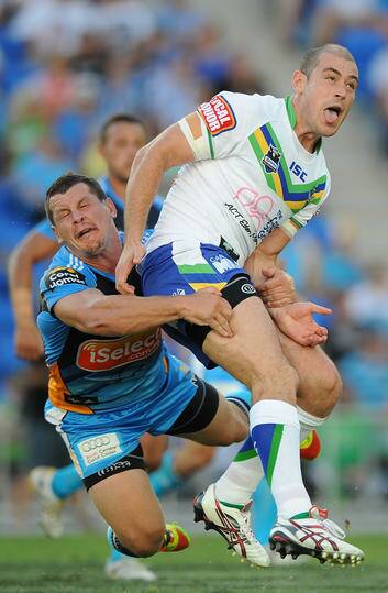 Greg Bird of the Titans tackles Terry Campese of the Raiders after kicking the ball during the round two NRL match between the Gold Coast Titans and the Canberra Raiders at Skilled Park on March 10, 2012 in Gold Coast, Australia.  (Photo by Matt Roberts/Getty Images) Photo: Matt Roberts