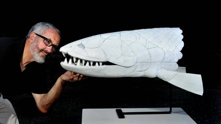 Dr Gavin Young and fellow ANU researches have discovered a new species of ancient fish they have named "Edenopteron Keithcrooki". Dr Young is pictured with a life size model of the fish built by Baz Crook, son of Professor Keith Crook, who the fish is named after. Photo: Melissa Adams