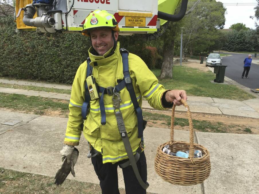 Senior Firefighter Stuart Laing with the basket of rescued baby magpies. Photo: Supplied