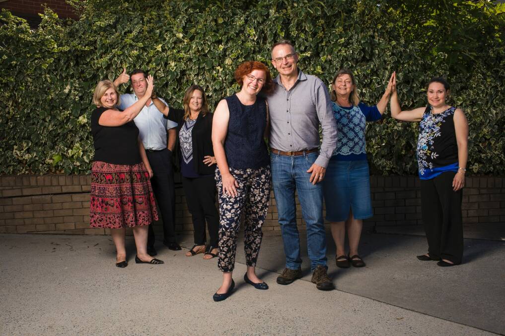 Celebrating a last minute reprieve from the ACT government are SHOUT chait Rebecca Davey and patron Jon Stanhope and other staff. Photo: Sitthixay Ditthavong