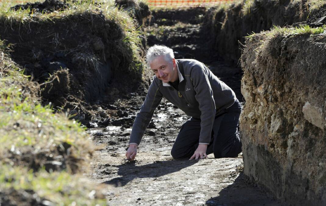 Dr. Tim Denham, convenor of the Master of Archeological Science
course at ANU, at a dig in the Jerrabomberra Wetlands where
remains of Army training trenches are being excavated.  Photo: Graham Tidy