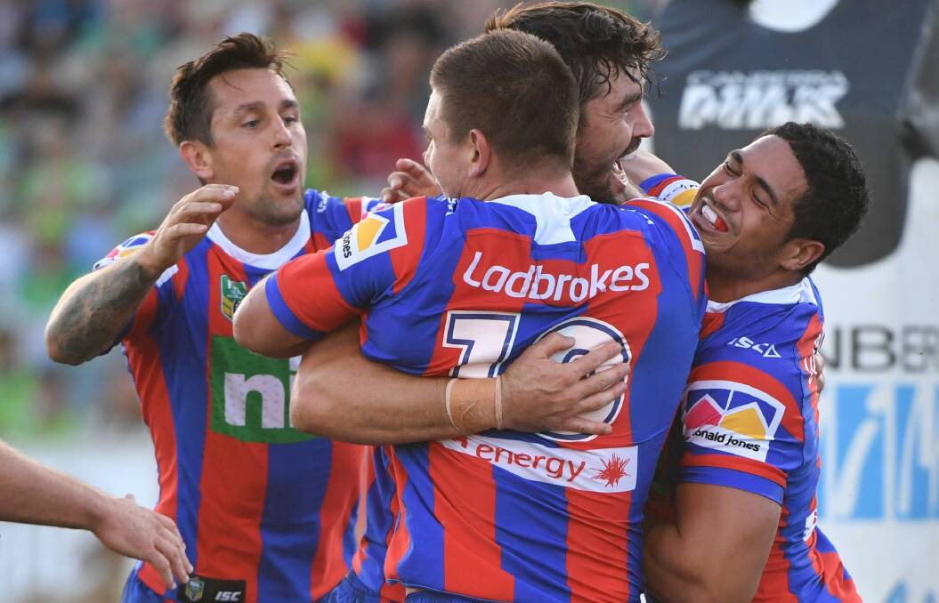 The Knights celebrate a try to Aidan Guerra.