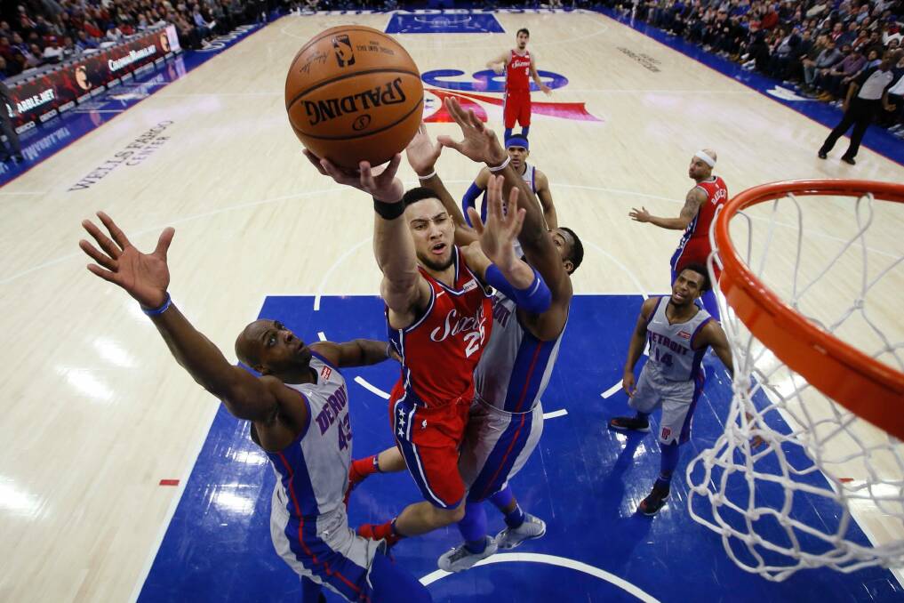 Philadelphia 76ers' Ben Simmons, centre, goes up for a shot between Detroit Pistons' Anthony Tolliver, left, and Andre Drummond during the first half of their NBA clash. Photo: AP