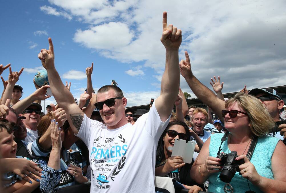 Sharks skipper Paul Gallen celebrates with fans at Shark Park on Monday. Photo: Louise Kennerley