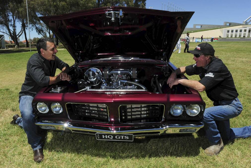 Site Manager for the car festival, Dave "Colorado" Chappell, right and Andy Lopez, Summernats co-owner, left, check out this immaculate HQ Holden Monaro GTS coupe.  Photo: Graham Tidy 