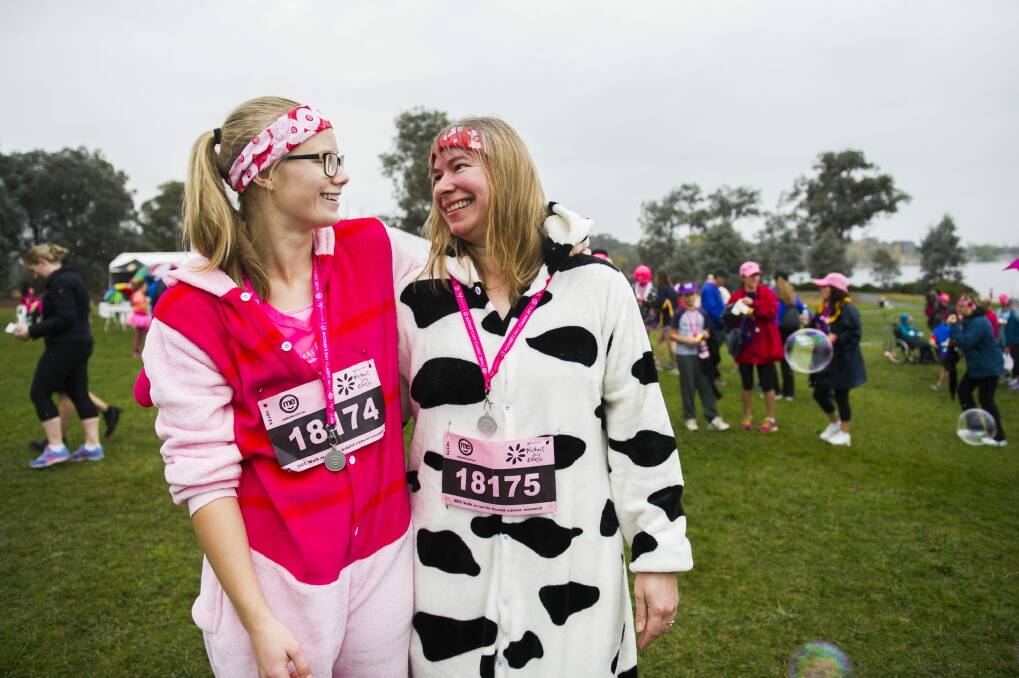 Team effort: Megan Peters and mum Sharon, of Dunlop, relax after running in onesies.  Photo: Rohan Thomson