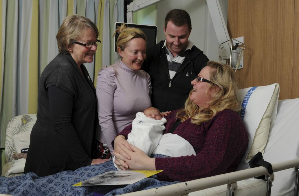 The 1000th baby born in the CaTCH program, Lucy Grace Cassells, with her mother Amy Hicks and father Nick Cassells, at the Centenary Women and Children's hospital, Woden. At left is Christine Fowler, the clinical midwife manager, and second from left is midwife Felicity Finn.  Photo: Graham Tidy