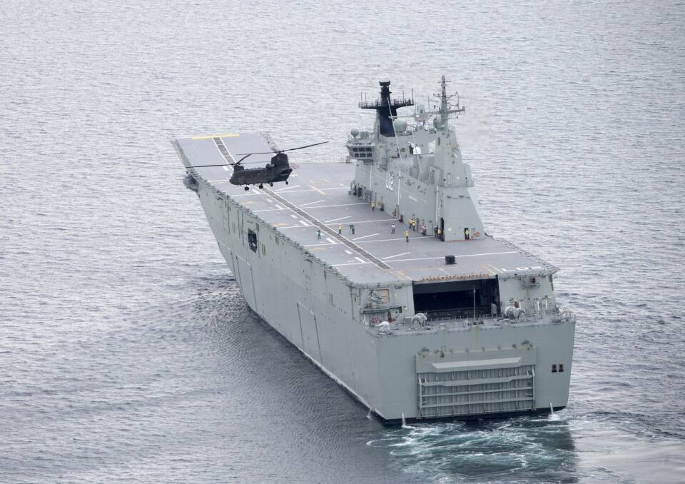 A CH-47D Chinook conducts load-lifting trials with HMAS Canberra. Photo: ADF