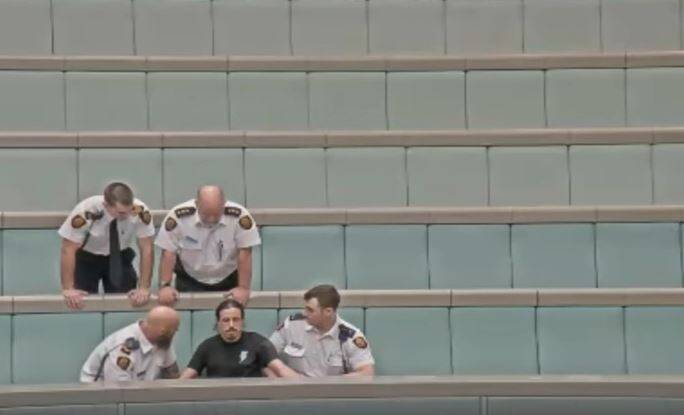 The seven protesters superglued themselves to a leather balustrade in the House of Representatives. Photo: Alexandra Back