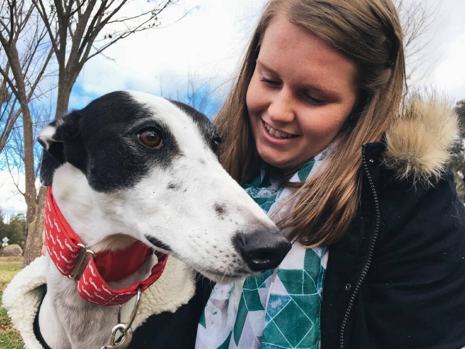 Emily Smith of Isabella Plains with her dog Avery at a meeting with other greyhound owners on Saturday. Photo: Rohan Thomson