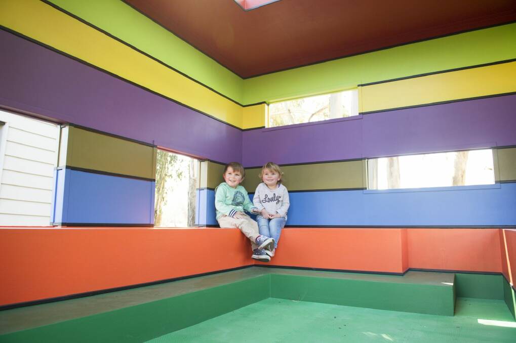 Tom, 3 and Lottie Searle, 2, are right at home in the Lego-themed cubby house for Floriade. Photo: Jay Cronan