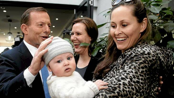 Tony Abbott and Liberal MP Kelly O'Dwyer meet with Amelia Taylor and 5-month-old Thomas during an election campaign visit to a Melbourne cafe to promote the paid parental leave scheme. Photo: Alex Ellinghausen