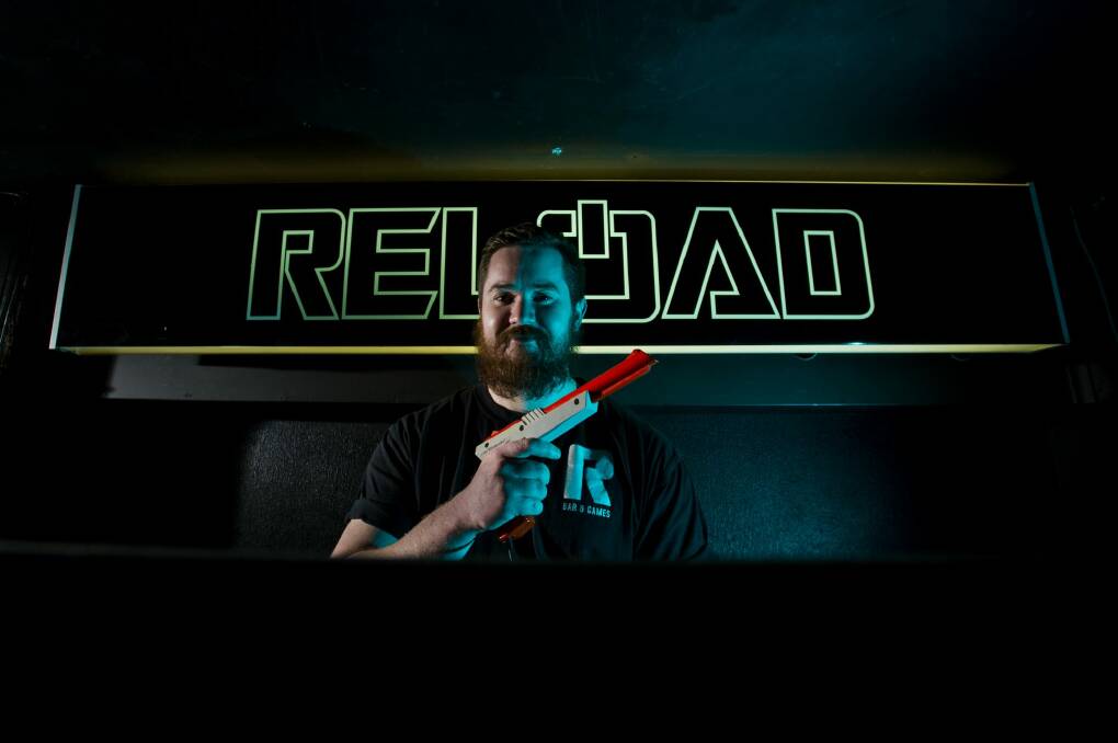 Hayden Ashley of Reload armed to play Point Blank as part of the Civic bar's Retro Gaming launch.  Photo: Jay Cronan
