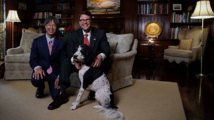 In the drawing room: US ambassador John Berry and partner Curtis Yee in the embassy library with artwork by Kevin Sloan. Photo: Andrew Meares