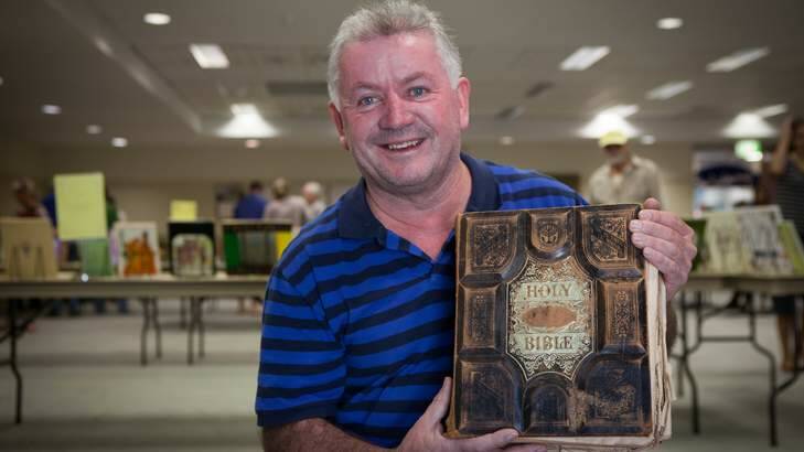 Denis Power of Gowrie finds a rare Holy Bible from the 18th century at the Lifeline Book Fair. Photo: Katherine Griffiths