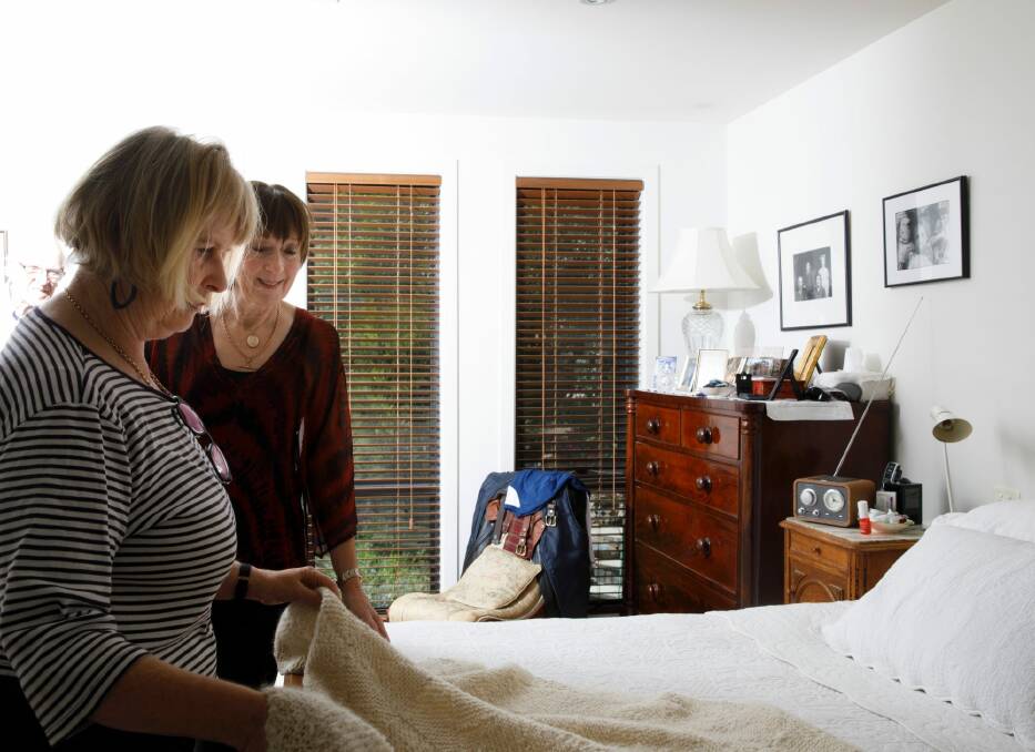 After the 2003 Canberra fires destroyed Janet Walker's (right) home, neighbour, close friend, and accomplished knitter Jenny Manning said that she would knit Janet a special blanket if she agreed to stay and rebuild. The blanket has stayed on the Walkers bed for 15 years. Photo: Sitthixay Ditthavong