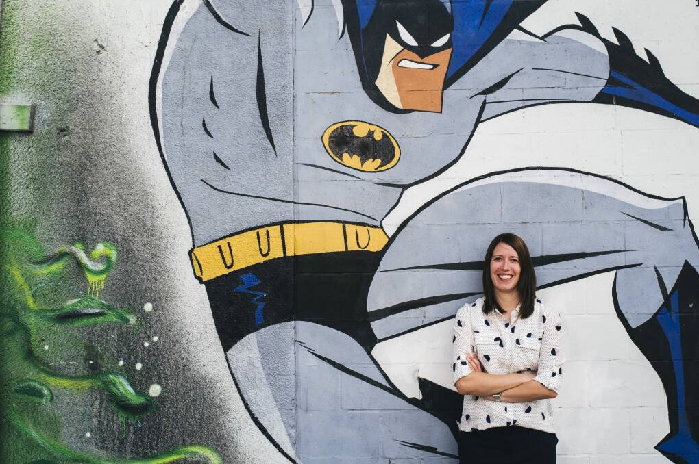 The ACT's new graffiti co-ordinator Louise Emberson with legal street art in Tocumwal Lane off Garema Place. Photo: Rohan Thomson