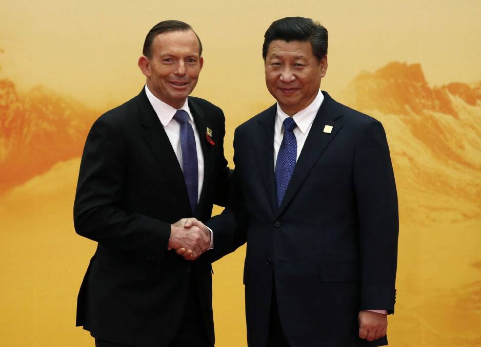 Australia's Prime Minister Tony Abbott shakes hands with China's President Xi Jinping during a welcoming ceremony at the Asia Pacific Economic Cooperation (APEC) forum.