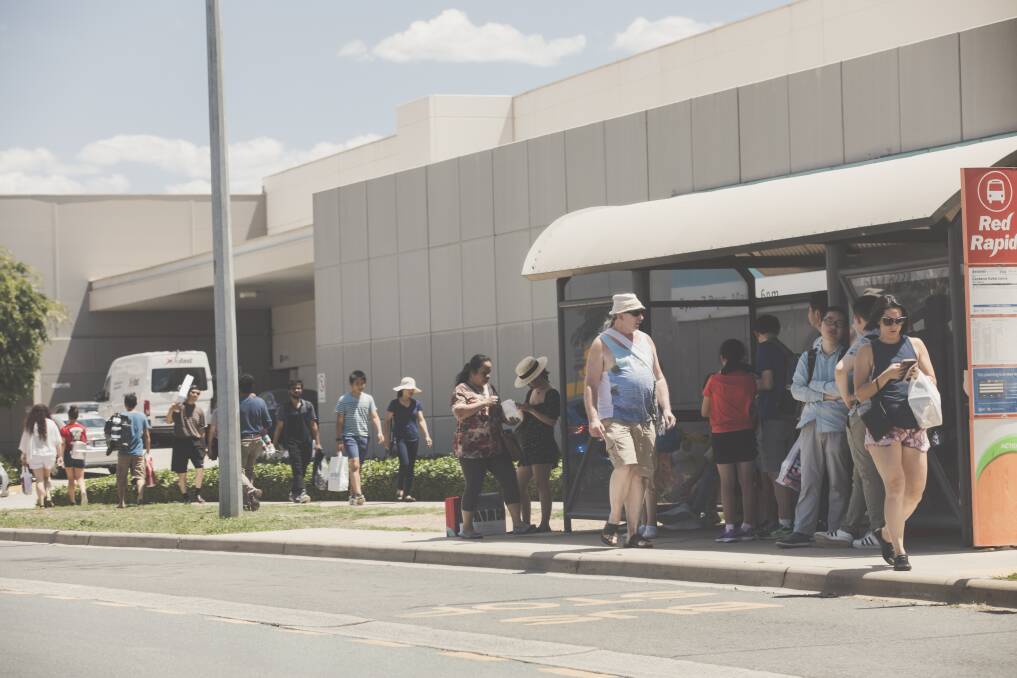 Boxing Day sales crowds wait for a bus on Iron Knob Street outside the Canberra Outlet Centre in Fyshwick. Photo: Jamila Toderas