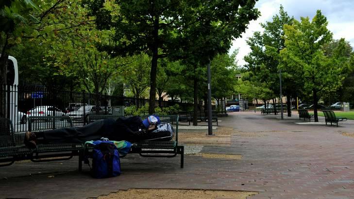 A homeless man sleeps on a park bench in Glebe Park, March 2013. Photo: Jay Cronan