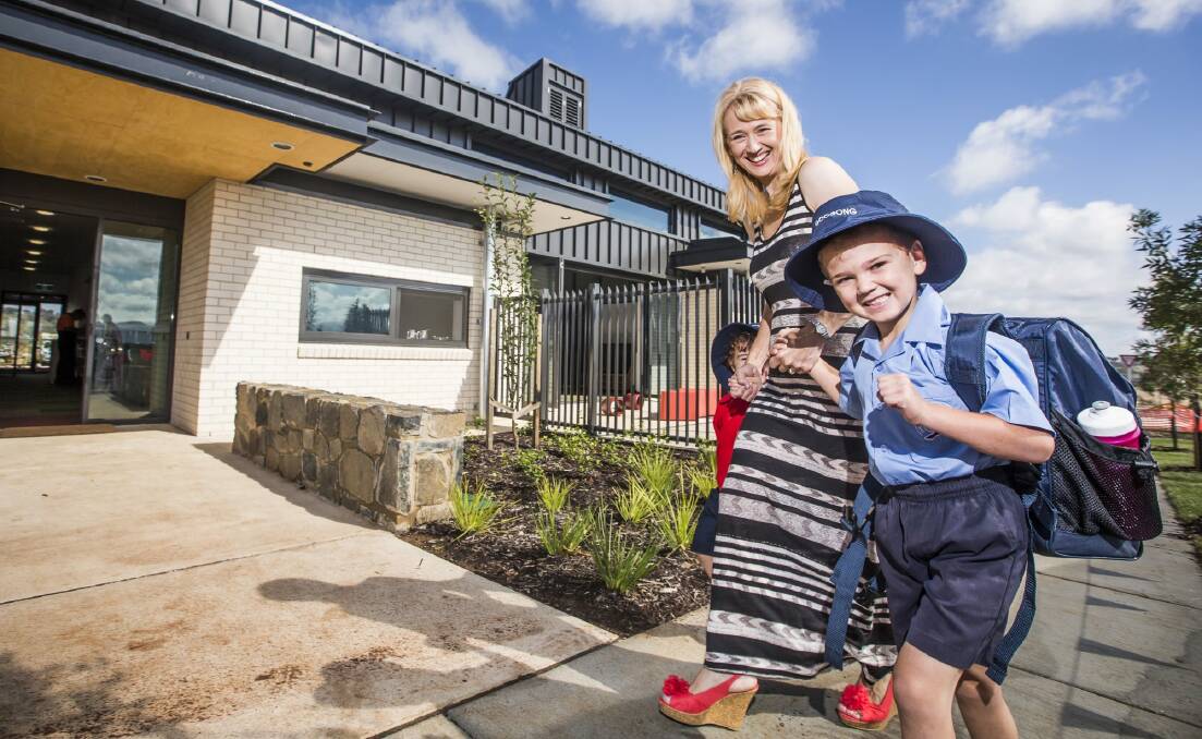 Rachel Howden with her boys Alex, 3, and year 1 student Toby, 6, on their first day at the new Anglican School Googong. Photo: Matt Bedford