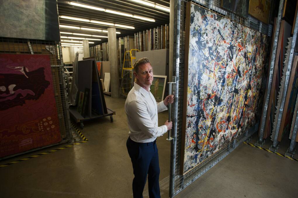 The National Gallery of Australia's assistant director of exhibitions and collections Adam Worrall with Jackson Pollock's <i>Blue Poles</i> in storage before it goes into the conservation lab. Photo: Elesa Kurtz