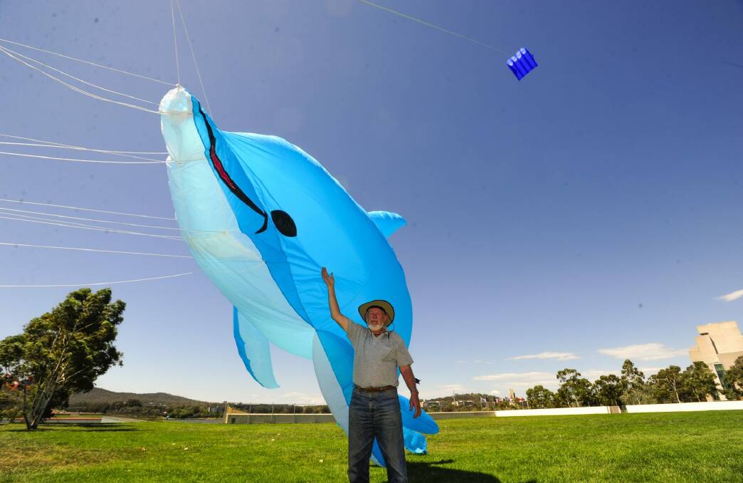 Kite flyer, Ian Burrell of Gowrie takes advantage of the windy conditions in Canberra. Photo: Melissa Adams