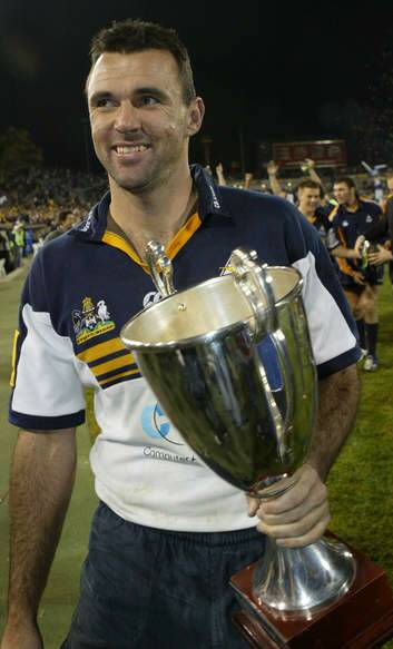 Brumbies great Joe Roff with the Super 12 trophy in 2004.