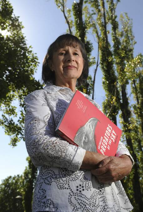 Canberra-based author Penny Olsen, outside the National Library of Australia with her book, "Australian Predators of the Sky". Photo: Graham Tidy