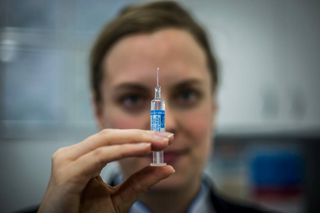 Chemist Elise Apolloni administers an injection at the Wanniassa Capital Chemist. Photo: Karleen Minney