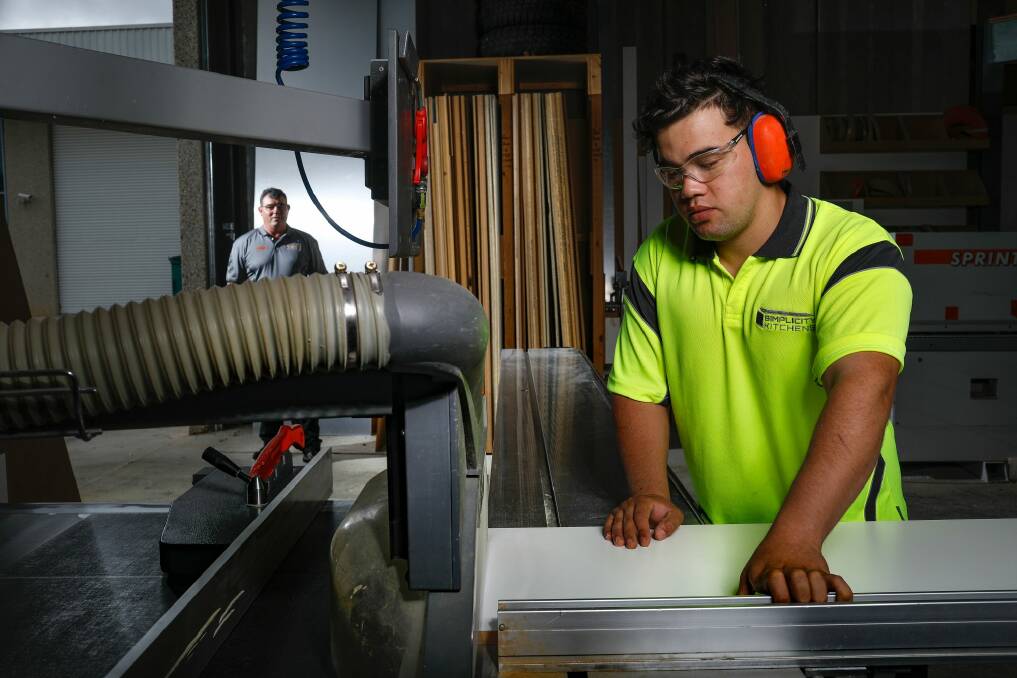 David Jackson, owner of Simplicity Kitchens, watches second-year apprentice in cabinet making Jawad Haidari in the workshop. Photo: Sitthixay Ditthavong