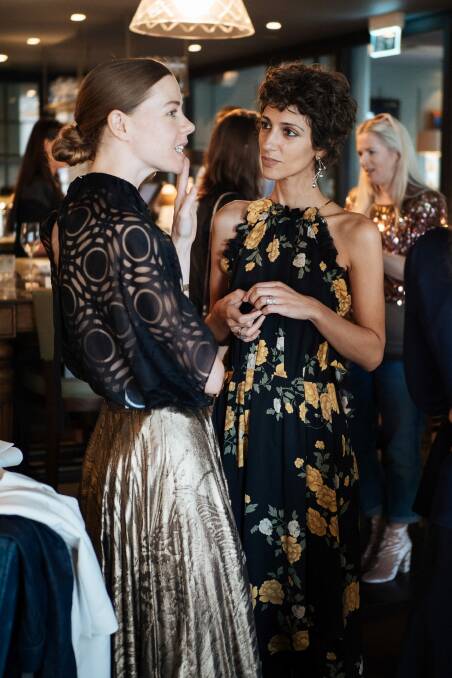 Style.com fashion director and co-founder of Etre Cecile, which is stocked by Myer, Yasmin Sewell (right) chats with fashion designer Bianca Spender, who is stocked in David Jones, during Fashion Week Australia. Photo: Giuseppe Santamaria