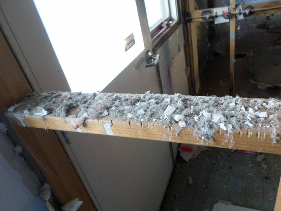 Loose fill asbestos found in wall cavity at the first Mr Fluffy demolition in Wanniassa.  Photo: ACT Asbestos Taskforce