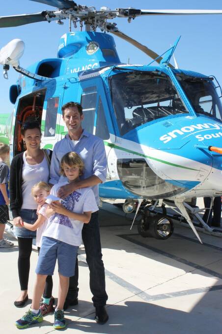 Chris Kimball with his wife, Kerri, and children Violet and Noah with the Snowy Hydro Southcare helicopter. Photo: Supplied