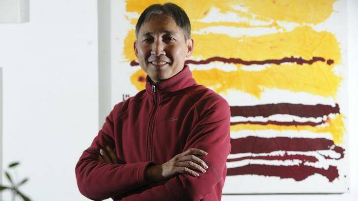 Hou Leong with his painting <i>Red and Yellow Horizontal Lines.</i> Photo: Graham Tidy
