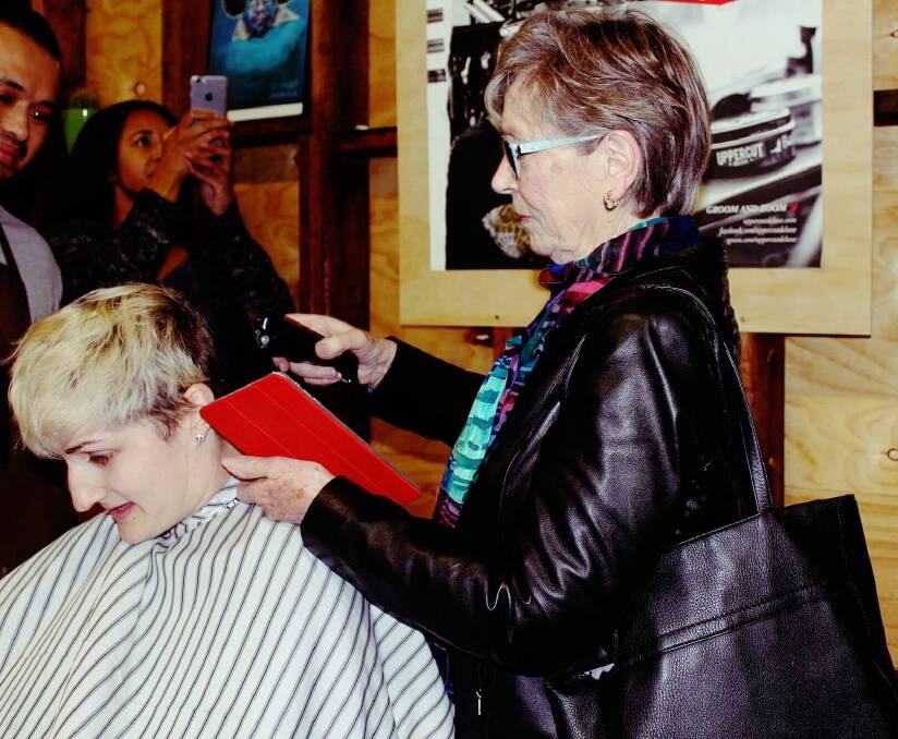 Shelley West at The Barber Shop in Braddon as her grandmother Sue Davis takes up the clippers.  Photo: Supplied