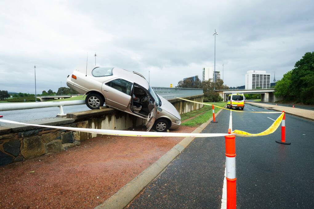 The car managed to wedge itself on the barrier of the Commonwealth Avenue on-ramp. Photo: Dion Georgopoulos
