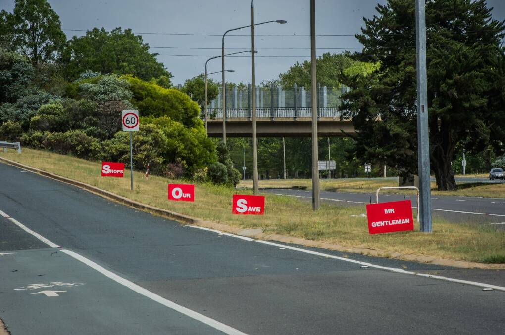 Signs on the side of Adelaide avenue saying Mr Gentleman Save Our Shops.  Photo: karleen minney
