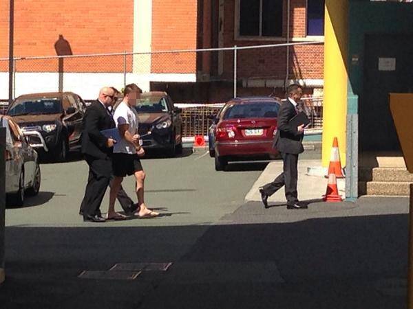 Detectives lead a handcuffed Gable Tostee to the watchhouse. Photo: Nine News
